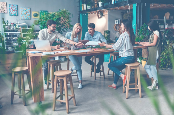 Group of young multiracial business people are working in modern office. Freelancers in coworking place. Creative and stylish youth.