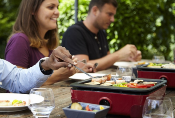 Man changing light bulb in pendant lamp indoors