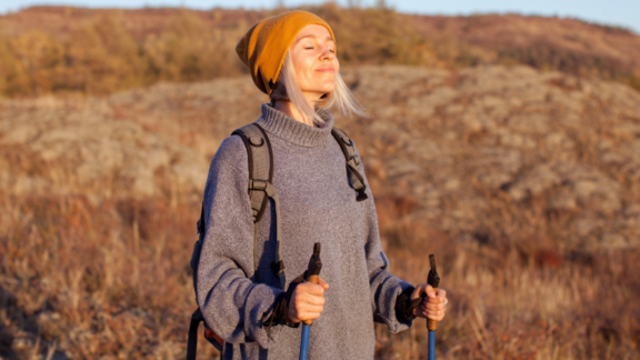 Beautiful young couple in love at home, celebrating with a gift box exchange, kissing