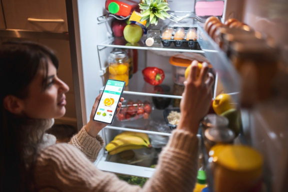 Man changing light bulb in pendant lamp indoors