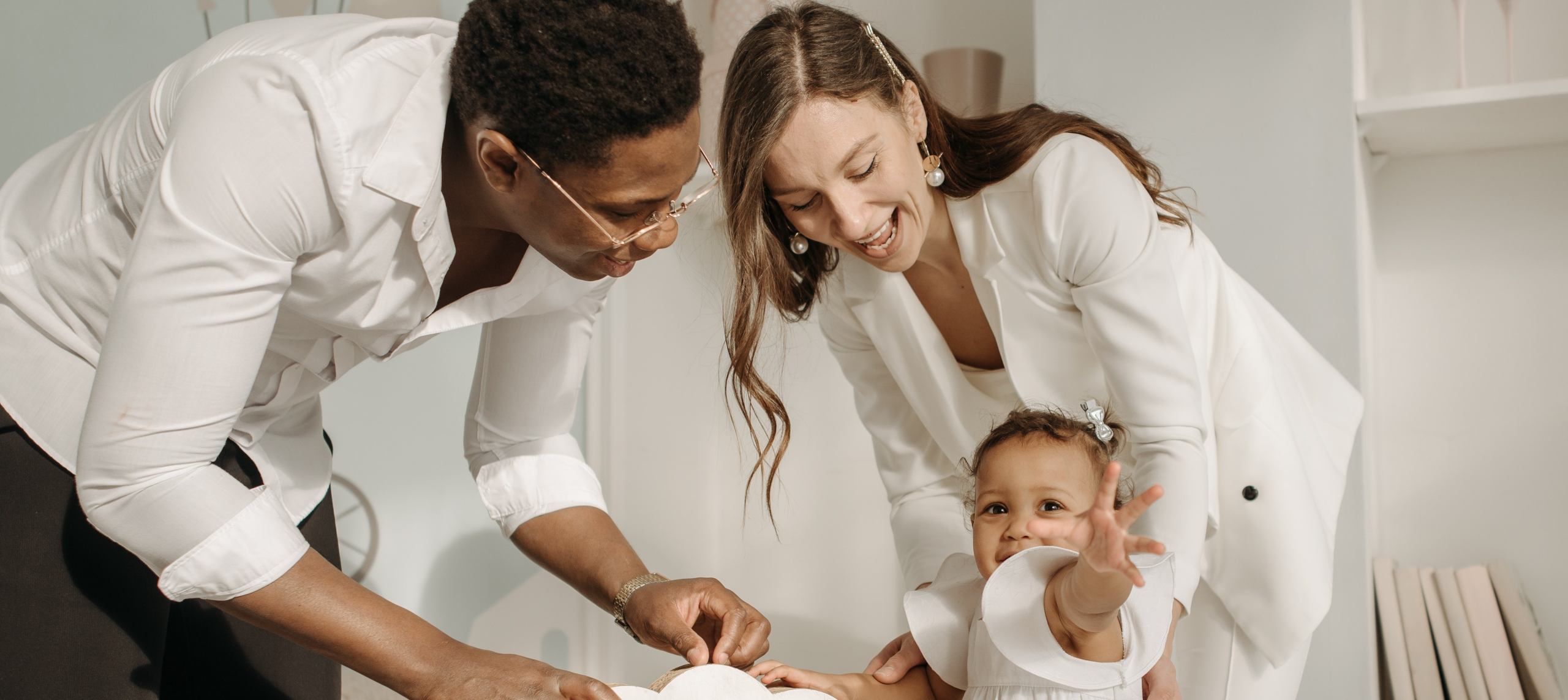 Image of smiling family mother and little daughter hugging and taking selfie photo on cellphone while having breakfast at home in morning