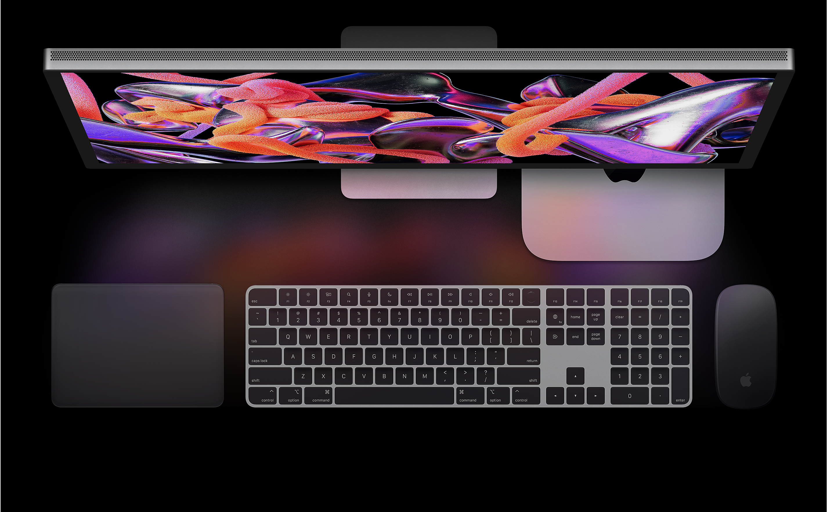 Studio Display, Mac mini, Magic Trackpad, Magic Keyboard et Magic Mouse vus d’en haut.