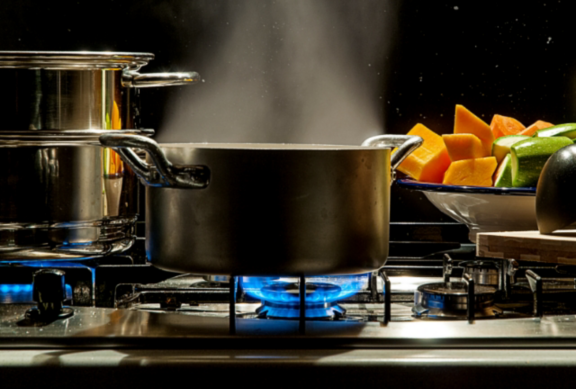 Man changing light bulb in pendant lamp indoors